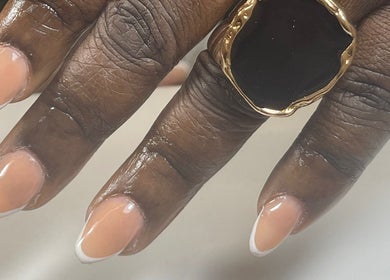Beautiful French manicure at Nail Kulture, Rochdale, England, GB. Close-up of polished nails and ring.