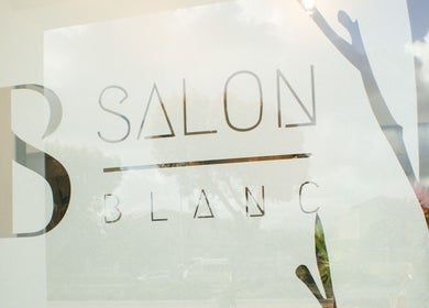 Front window of Salon Blanc, Cape Town, Western Cape, ZA showcasing stylish branding.