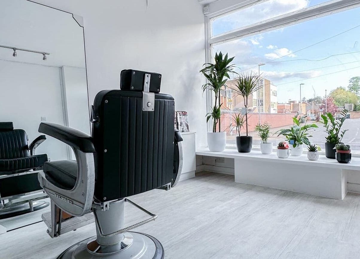 Stylish barber chair and plants at Solomengroomingsalon, Beeston, England, GB with bright natural light.