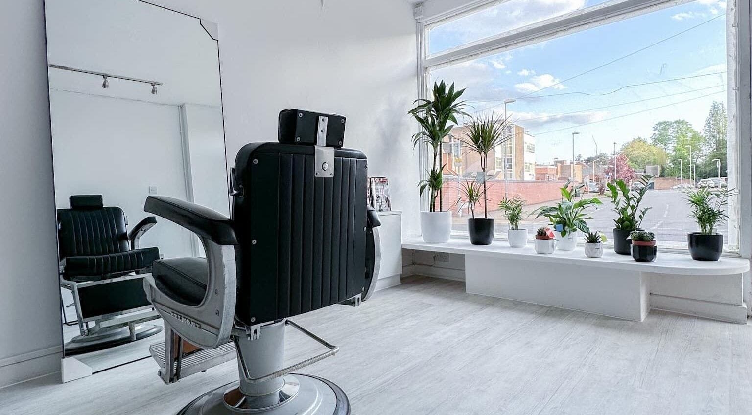 Stylish barber chair and plants at Solomengroomingsalon, Beeston, England, GB with bright natural light.