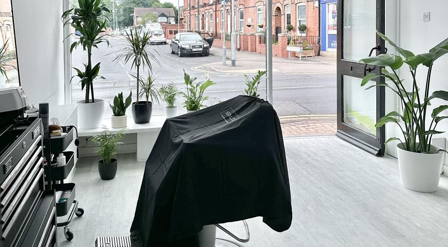 Chic interior of Solomengroomingsalon in Beeston, England, GB with modern design and lush plants.