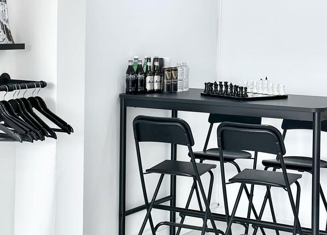 Modern waiting area with chess set at Solomengroomingsalon, Beeston, England, GB.