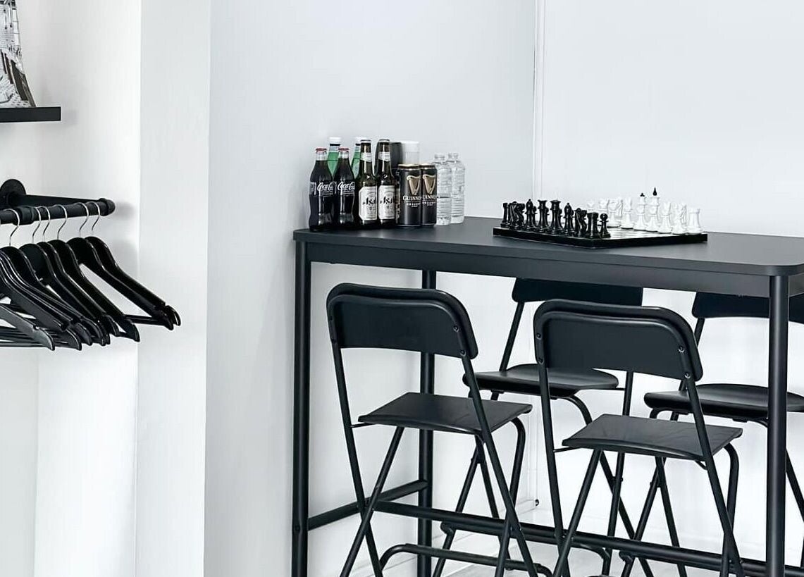 Modern waiting area with chess set at Solomengroomingsalon, Beeston, England, GB.