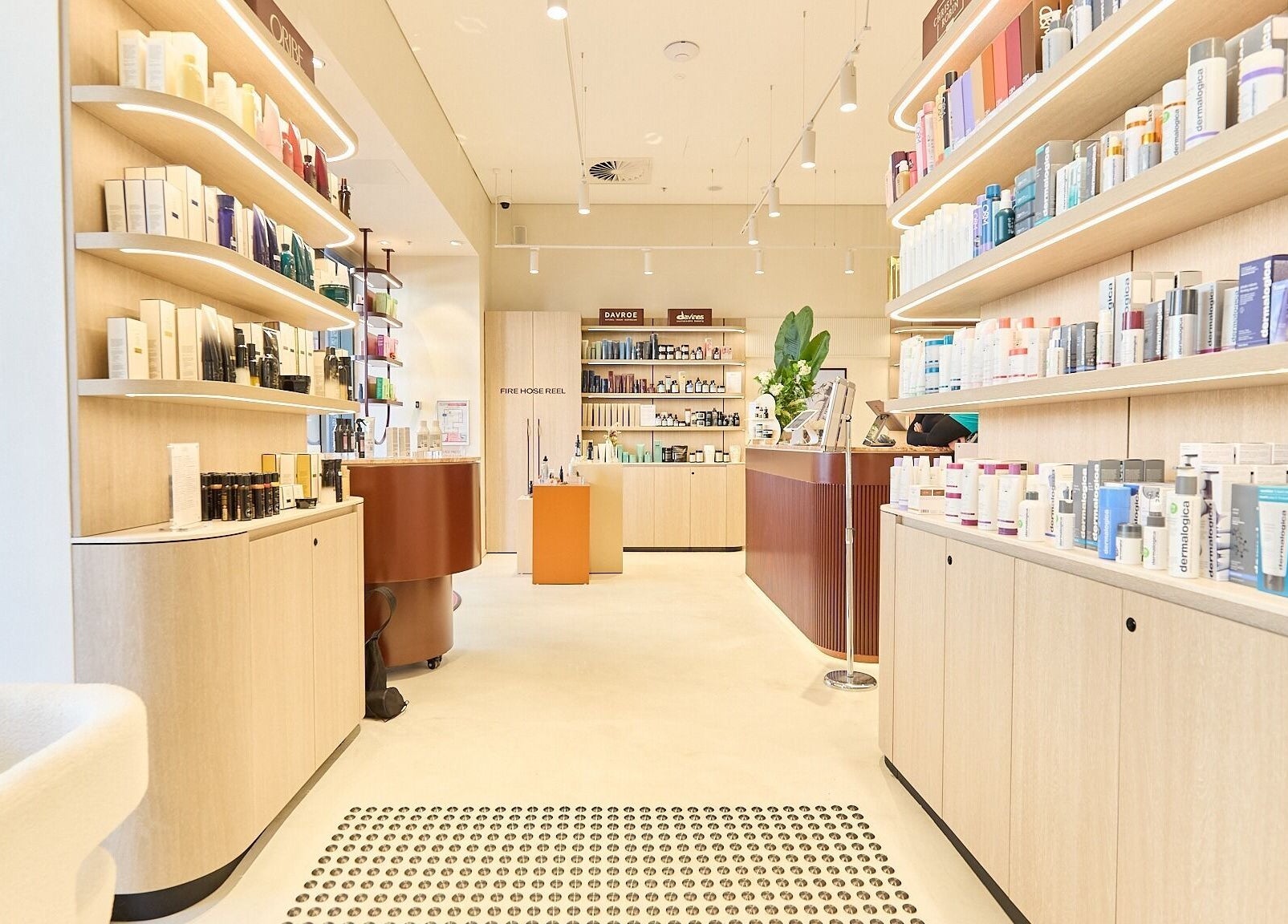 Bright, modern interior of Cosmetics By Nurse Blake, Bondi Junction, New South Wales, AU. Shelves lined with products.