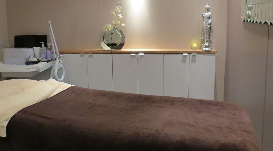 Relaxing treatment room at Total Image Beauty, Banbury, England, GB, with a plush bed and elegant decor.