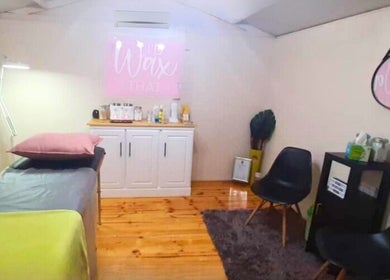 Serene wax room at DMA Beauty, Cape Town, Western Cape, ZA, featuring modern decor and comfortable seating.