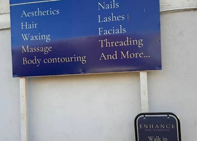 Signboard at Enhance Taunton offering aesthetics and wellness services in Taunton, England, GB.