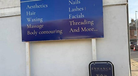 Signboard at Enhance Taunton offering aesthetics and wellness services in Taunton, England, GB.