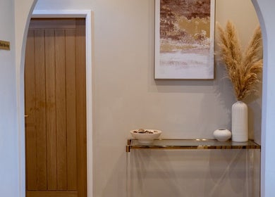 Stylish entry at Enhance Taunton, Taunton, England, GB with wood door, arch, and decorative accents.