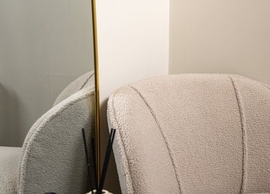 Elegant corner at Enhance Taunton in Taunton, England, GB with plush chair and gold-framed mirror.