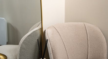 Elegant textured chair with a mirror at Enhance Taunton, Taunton, England, GB. Ideal for relaxation.