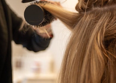 Hair styling with brush at Enhance Taunton, Taunton, England, GB. Experience expert blow-dry services.
