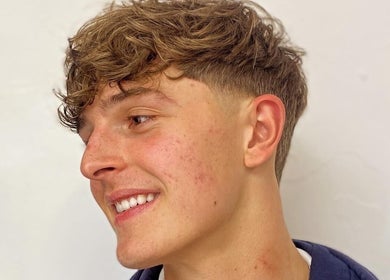 Youthful haircut at Meister Fades, Cape Town, Western Cape, ZA highlighting modern grooming style.