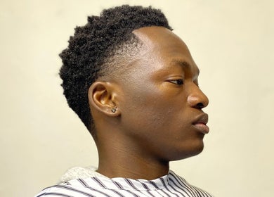 Stylish fade haircut at Meister Fades, Cape Town, Western Cape, ZA, showcasing modern grooming.