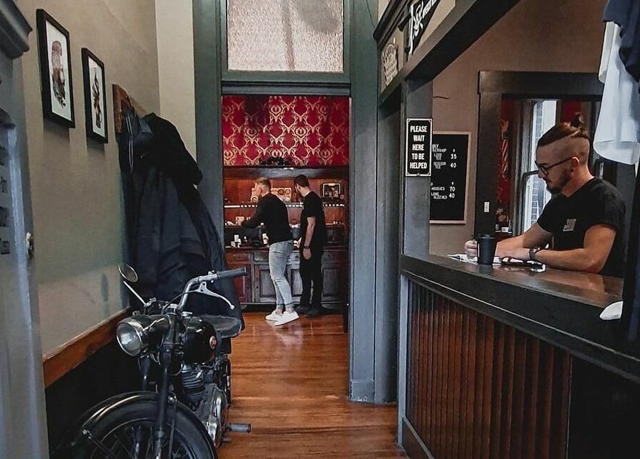 Inside The Kingsway Barbershop in Launceston, Tasmania, AU showcasing vintage decor and attentive staff.