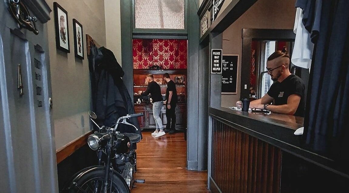 Inside The Kingsway Barbershop in Launceston, Tasmania, AU showcasing vintage decor and attentive staff.