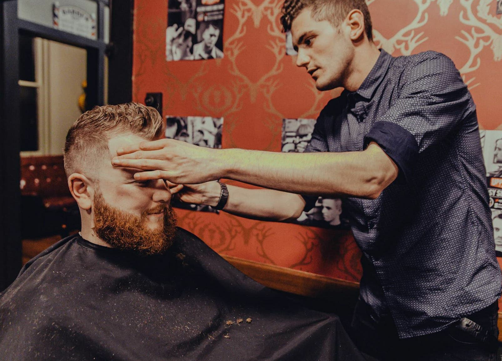 Barber styling a client's hair at The Kingsway Barbershop, Launceston, Tasmania, AU.