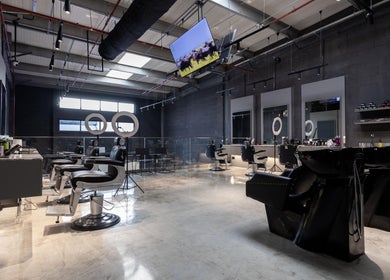 Modern interior of Lvls Barbershop in Dubai, Dubai, AE showcasing barber chairs and sleek design.