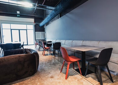 Stylish seating at Lvls Barbershop, Dubai, Dubai, AE, featuring modern tables and chairs in a sleek setting.