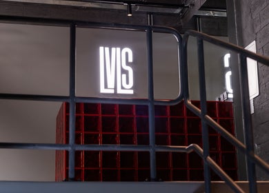 Stylish stairway at Lvls Barbershop, Dubai, AE with modern decor and illuminated sign.