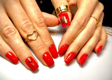 Elegant red nails with gold accents at NatTal Beauty, Worcester, England, GB.
