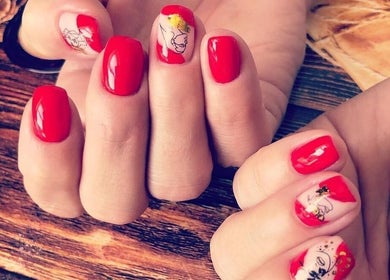 Stylish red manicure with art details at NatTal Beauty, Worcester, England, GB.