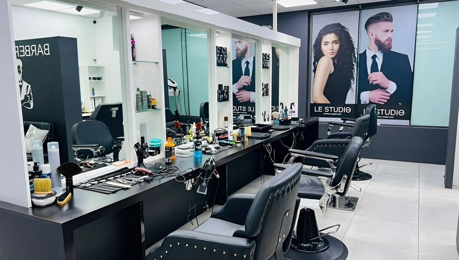 Modern salon interior of LE STUDIO TAMARIN, Tamarin, Rivière Noire, MU with stylish barber chairs and decor.