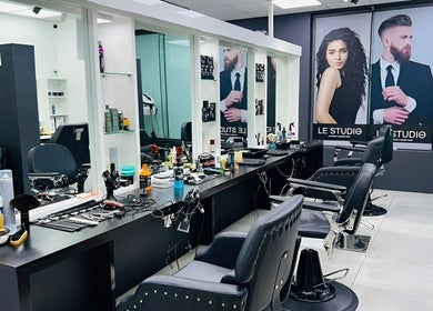 Modern salon interior of LE STUDIO TAMARIN, Tamarin, Rivière Noire, MU with stylish barber chairs and decor.