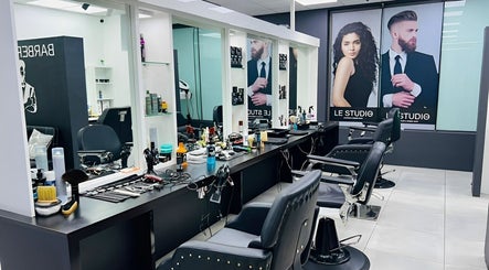 Modern salon interior of LE STUDIO TAMARIN, Tamarin, Rivière Noire, MU with stylish barber chairs and decor.