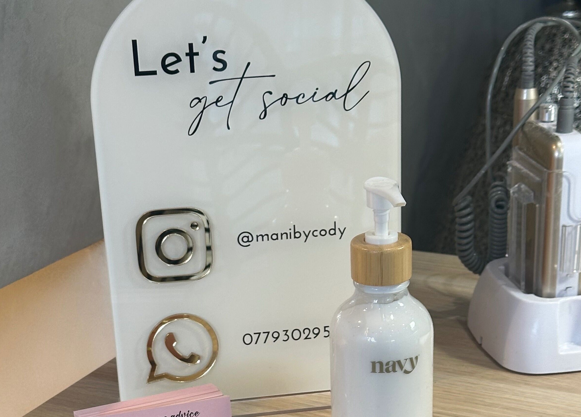 Mani by Cody Thompson sign and lotion bottle on display, Solihull, England, GB.