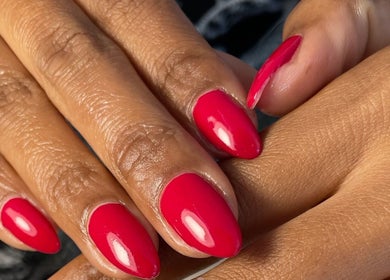 Bright red manicure at D'ntle Beauty Randburg, Gauteng, ZA, showcasing elegant, glossy nail art.