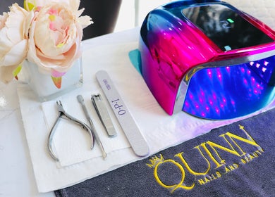 Nail tools and LED lamp at Quinn Nails and Beauty Richmond, Richmond, England, GB, with a floral decor.