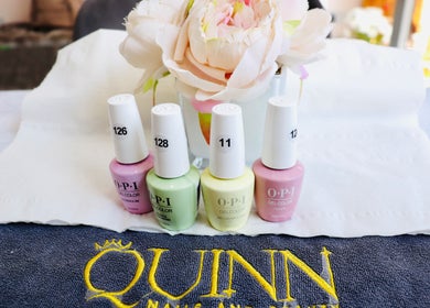 OPI nail polishes displayed at Quinn Nails and Beauty Richmond, Richmond, England, GB with a floral backdrop.