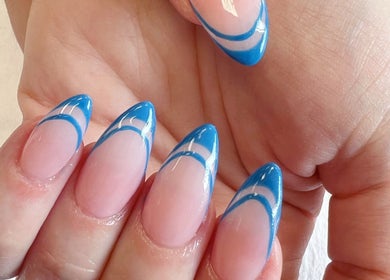 Elegant blue-tipped nails at Quinn Nails and Beauty Richmond, Richmond, England, GB enhance a stylish look.