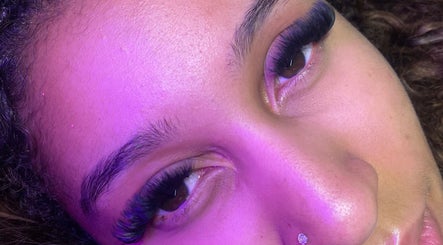 Close-up of luxurious eyelashes at Blinked Boutique, London, England, GB, under soft purple lighting.