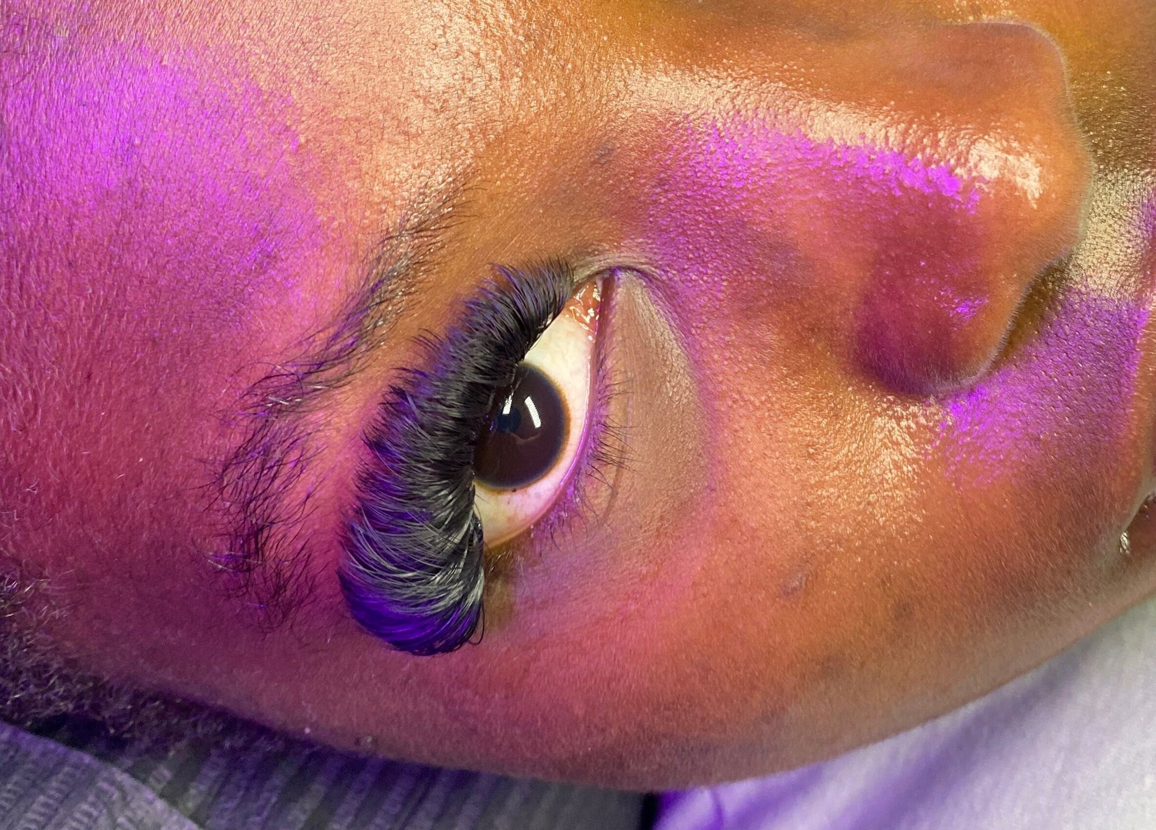 Close-up of stunning eyelash extensions at Blinked Boutique, London, England, GB, highlighted by subtle lighting.
