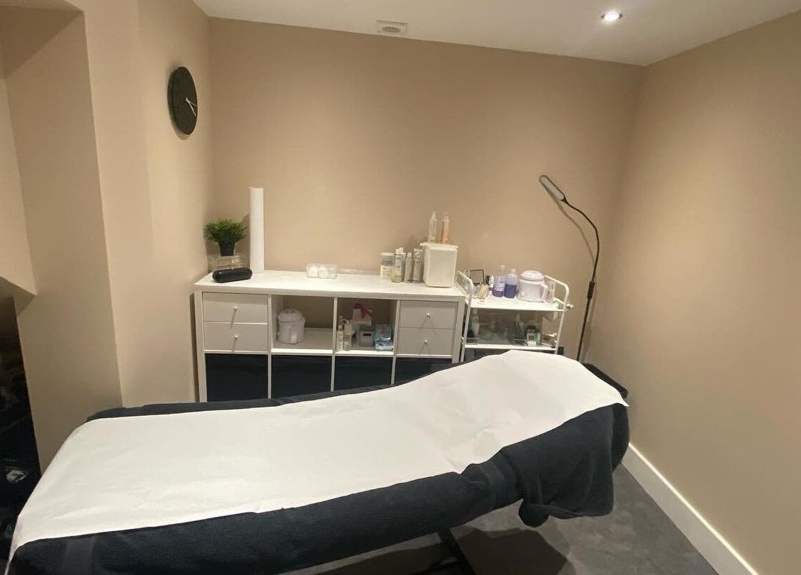 Tranquil treatment room at Beyond Beauty by Louise in Ayr, Scotland, GB, featuring a therapy bed and modern decor.