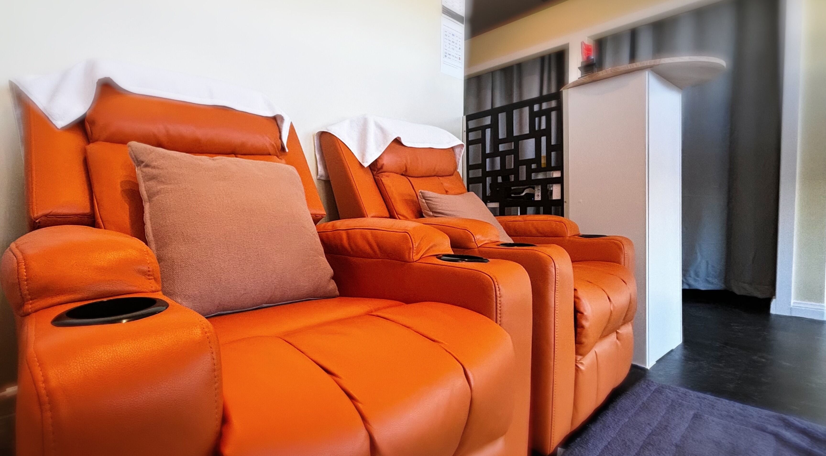 Relax in plush, orange recliners at Swan Massage, Osborne Park, Western Australia, AU for a soothing experience.