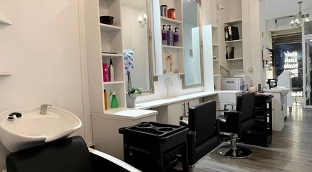 Modern interior of HASO London in London, England, GB, featuring salon chairs, mirrors, and elegant decor.