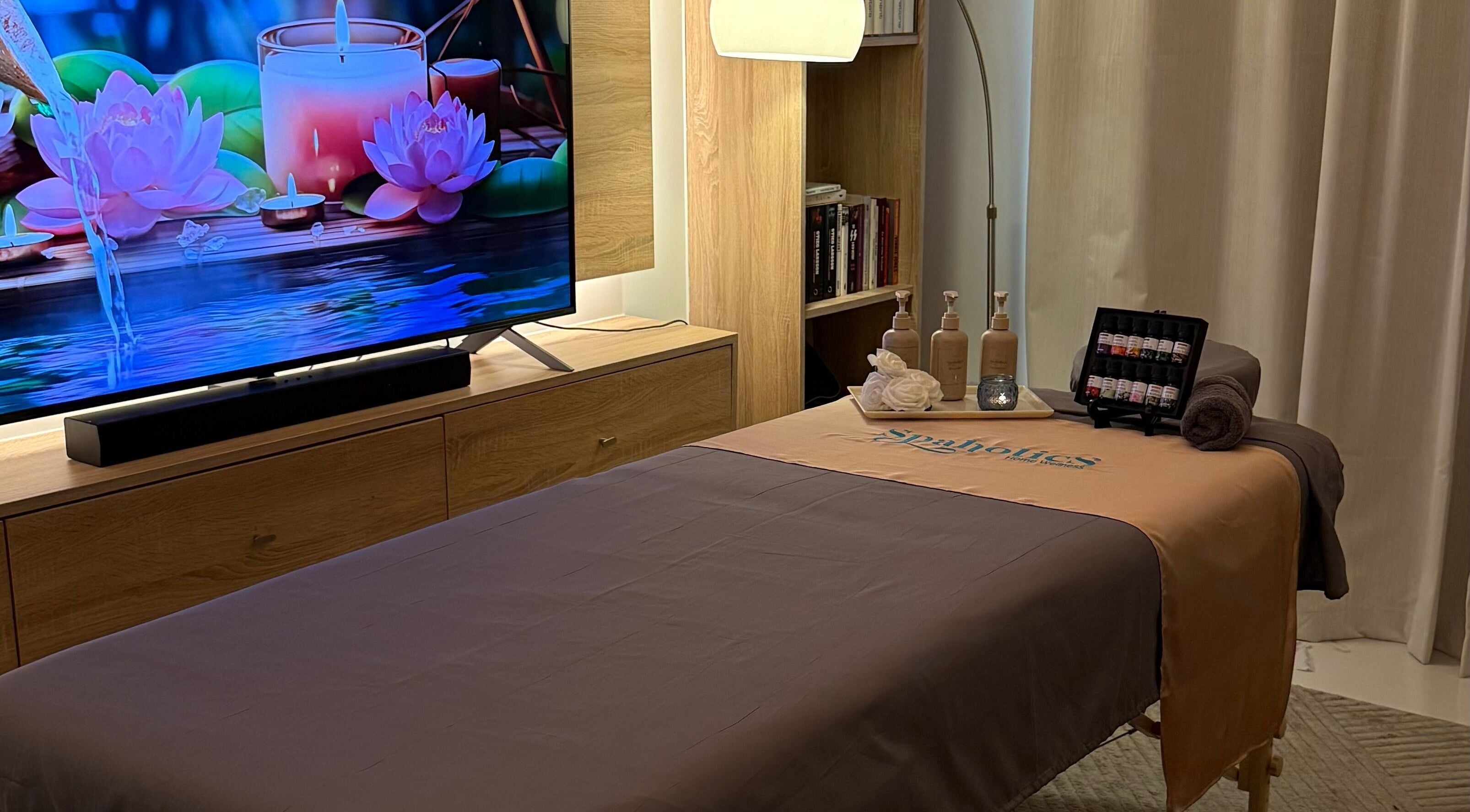 Relaxing spa room at Spaholics Home Wellness in Dubai, Dubai, AE with massage bed and calming decor.