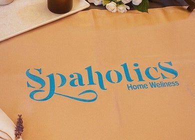 Spaholics Home Wellness logo on a relaxation mat with candles and flowers in Dubai, Dubai, AE.