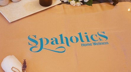 Spaholics Home Wellness logo on a relaxation mat with candles and flowers in Dubai, Dubai, AE.