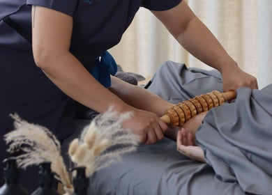 Therapist performing massage at Spaholics Home Wellness, Dubai, Dubai, AE, with calming ambiance.