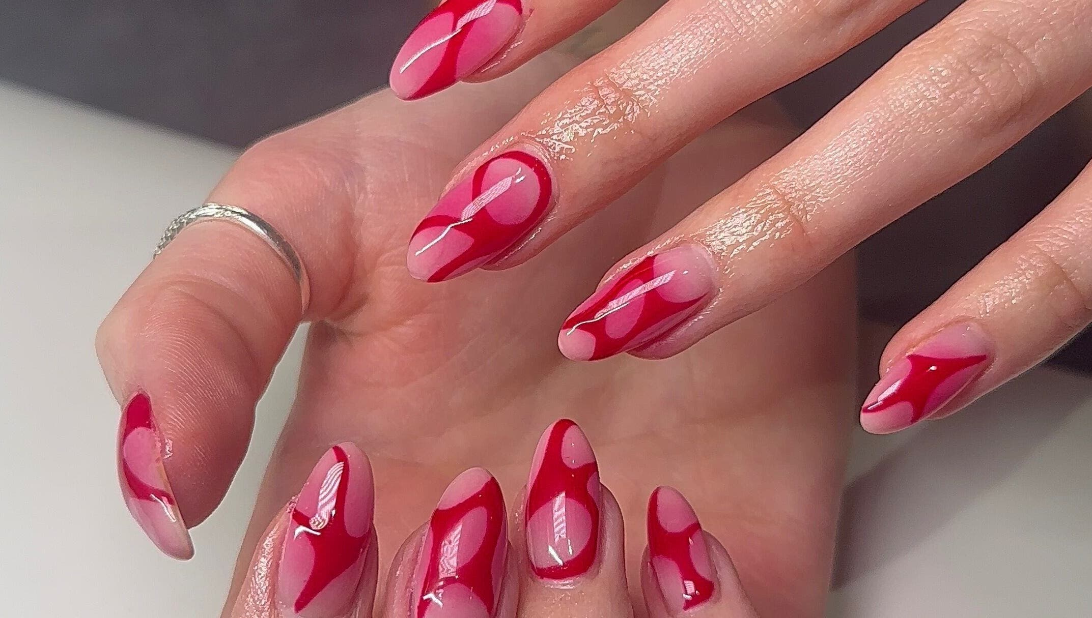 Red artistic nail design at Beauty by H.E.R, Moulton, England, GB.