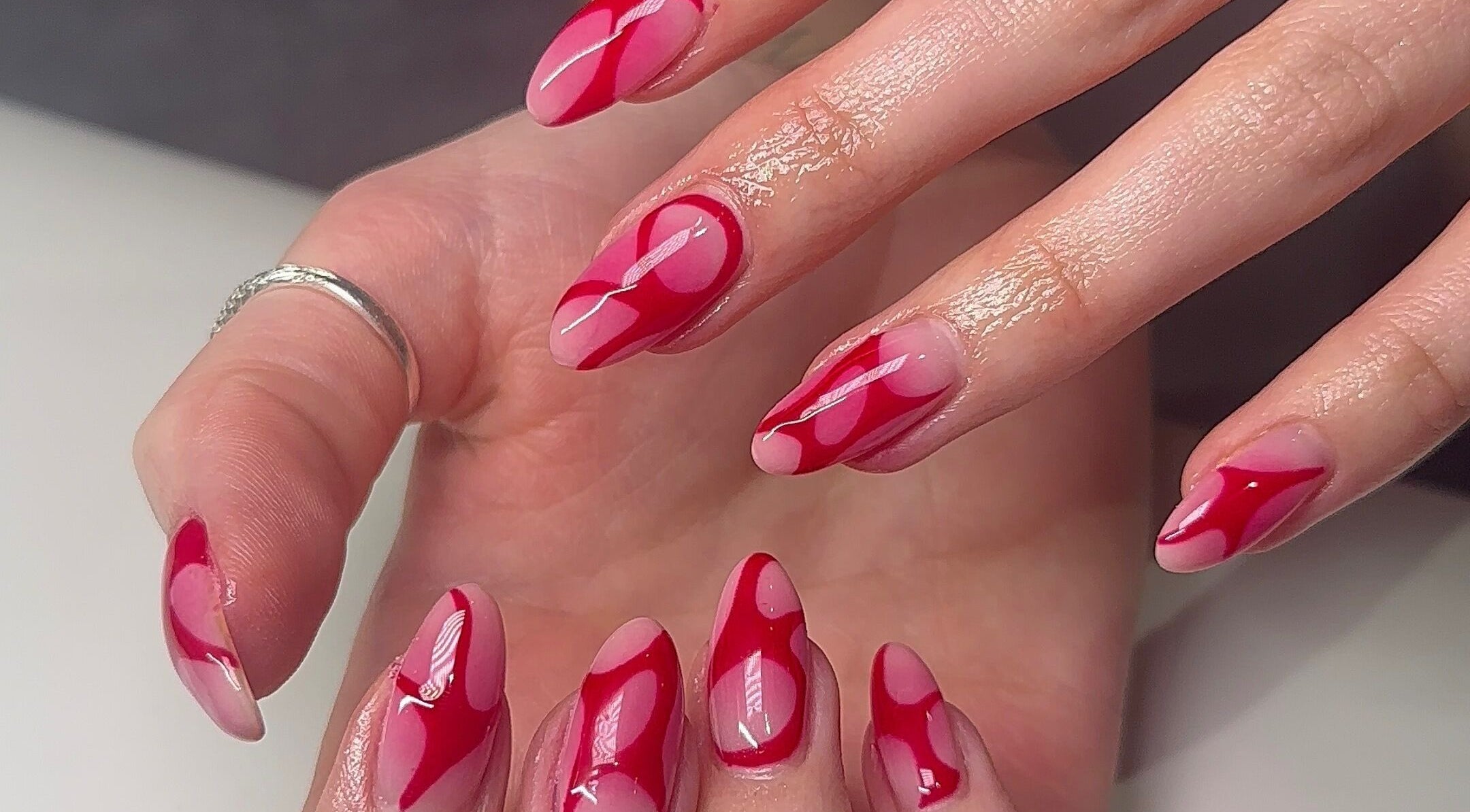 Red artistic nail design at Beauty by H.E.R, Moulton, England, GB.