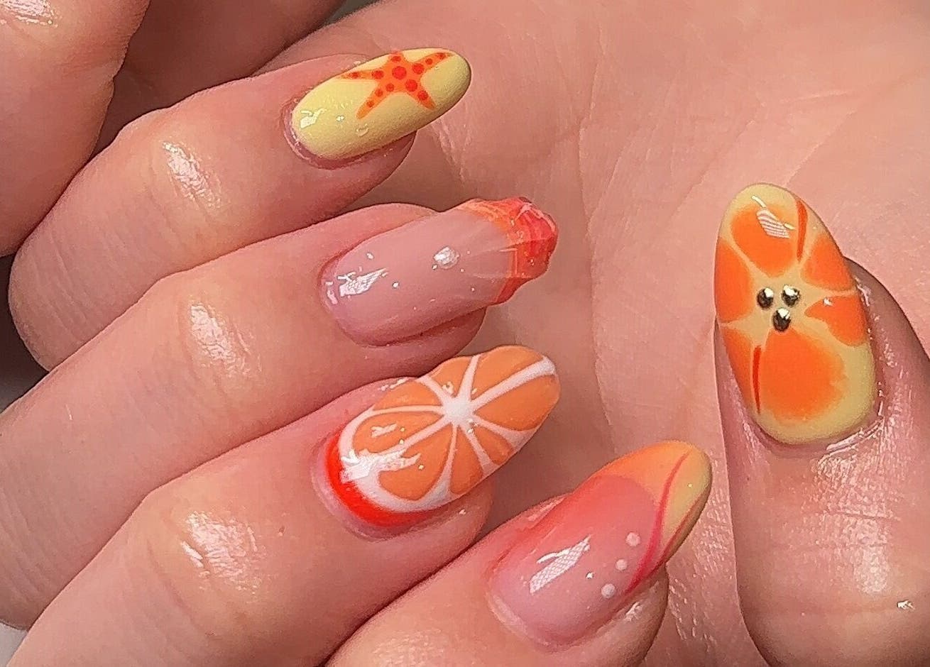 Vibrant orange tropical nail art by Beauty by H.E.R in Moulton, England, GB.