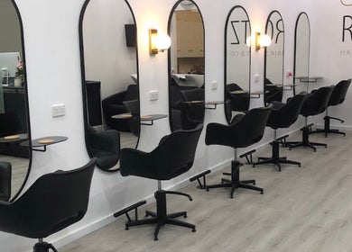 Sleek salon setup at Celtic Rootz & Co, Bangor, New South Wales, AU, featuring stylish black chairs.