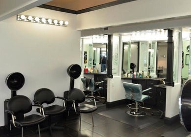 Modern salon interior at Hair By Jessie G, Hedgesville, West Virginia, US, featuring styling stations and dryers.