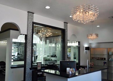 Reception area of Hair By Jessie G, Hedgesville, West Virginia, US with sleek design and chandeliers.