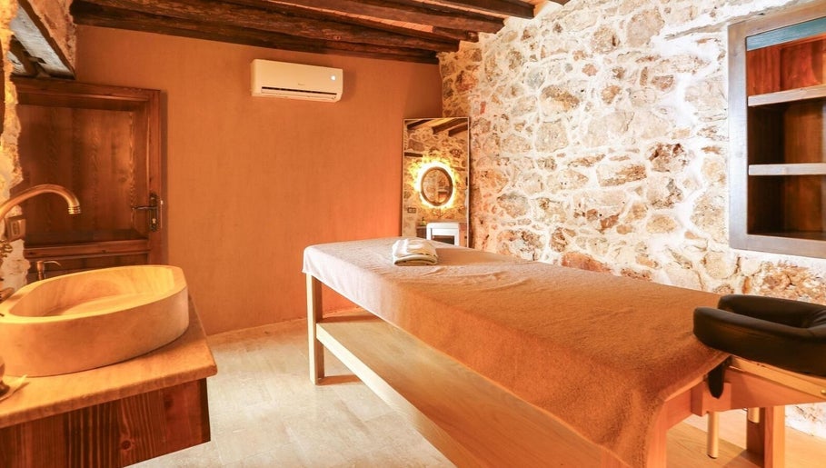 Tranquil massage room at Payam Spa & Wellness, Antalya, Antalya, TR with rustic stone walls and warm lighting.